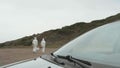 Unrecognizable scientists with bacteriological equipment walking outdoors