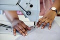 All is as it seams. an unrecognizable seamstress using a sewing machine while working in her boutique.