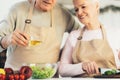 Unrecognizable Senior Couple Cooking Salad Preparing Dinner In Kitchen, Cropped Royalty Free Stock Photo