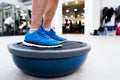 Unrecognizable senior man in gym standing on bosu balance ball Royalty Free Stock Photo