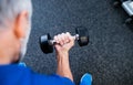 Unrecognizable senior man in gym working out with weights. Royalty Free Stock Photo