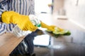 Unrecognizable senior woman cleaning kitchen counter indoors at home. Royalty Free Stock Photo