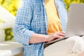 Unrecognizable senior woman using laptop for distance learning outdoors Royalty Free Stock Photo