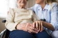 A senior woman in wheelchair with a health visitor at home at Christmas time. Royalty Free Stock Photo