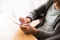 Unrecognizable senior woman in a wheelchair with tablet at home. Royalty Free Stock Photo