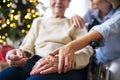 A senior woman in wheelchair with a health visitor at home at Christmas time. Royalty Free Stock Photo