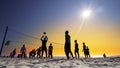 Unrecognizable Silhouette People Play Beach Volleyball at sunset