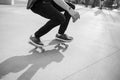 Unrecognizable skateboarder on his board. Black and white photo