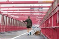 Unrecognizable sporty recreational male jogger with his dog on a leash at Williamsburg bridgein New York CIty, USA Royalty Free Stock Photo