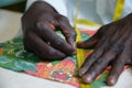 Unrecognizable tailor measuring fabric in his sewing shop using a measure tape Royalty Free Stock Photo