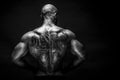 Back view of tattoed bodybuilder with outstretched arms Royalty Free Stock Photo