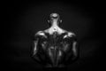 Back view of tattoed bodybuilder with outstretched arms Royalty Free Stock Photo