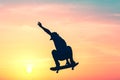 Unrecognizable teenage boy silhouette showing high jump tricks on scooter against Royalty Free Stock Photo