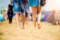 Unrecognizable teenage couple, tent festival, sunny summer, legs