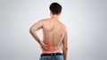 Unrecognizable topless man touching his lower back Royalty Free Stock Photo
