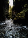 Unrecognizable tourist group walking into the narrow canyon