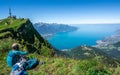 Unrecognizable tourist hiker admiring the aerial view of Lake Geneva from Rochers-de-Naye mountain summit in Switzerland