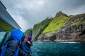 Unrecognizable tourists astonished at Vestmanna cliffs