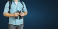 Young Traveler Man With Backpack And Binoculars Seeking Direction On Blue Background. Hiking Tourism Journey Concept