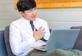 Unrecognizable unknown male businessman employee in formal business outfit sitting on cozy sofa couch with laptop holding hands on Royalty Free Stock Photo