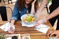 Unrecognizable waitres with gloves serving customers outdoors on terrace restaurant. Royalty Free Stock Photo