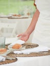 unrecognizable waitress putting the napkin on the wedding table