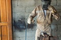 Unrecognizable welder wearing special protective helmet welding metal details using torch