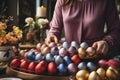 Unrecognizable woman assembling handmade easter gifts on table in creative workshop