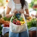 Unrecognizable woman buys fresh produce at farmers market with eco bag