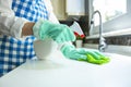Woman cleaning kitchen top with rag and spray cleaner Royalty Free Stock Photo