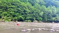 Unrecognizable woman crossing a mountain river ford