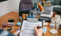 Woman doing checklist of emergency backpack