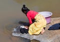 Unrecognizable woman doing the laundry in a river