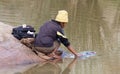 Unrecognizable woman doing the laundry in a river