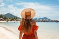 Unrecognizable woman embracing the summer sun and delighting in a blissful beach vacation