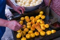 Unrecognizable woman grilling potato tortillas