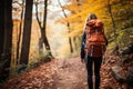 Unrecognizable woman hiking autumn forest trail with vibrant fall foliage in background Royalty Free Stock Photo