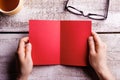 Unrecognizable woman holding empty red greeting card. Studio sho Royalty Free Stock Photo