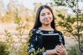 Young smiling christian girl holding a bible under her arm in the field. Sola scriptura. Copy space Royalty Free Stock Photo