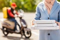 Unrecognizable Woman Holding Pizza Boxes Receiving Food From Courier Outdoor