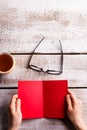 Unrecognizable woman holding red empty greeting card. Studio sho Royalty Free Stock Photo