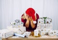 Unrecognizable woman housewife tired of wrapping Christmas presents in home. Stacks of gifts. Royalty Free Stock Photo