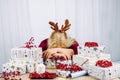 Unrecognizable woman housewife tired of wrapping Christmas presents in home. Stacks of gifts. Royalty Free Stock Photo