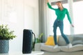 Unrecognizable woman listening to music via music speaker and dancing on sofa, enjoying great playlist, selective focus Royalty Free Stock Photo