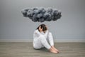 Unrecognizable woman with mental disorder and suicidal thoughts under a dark storm cloud Royalty Free Stock Photo