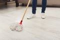 Unrecognizable woman with mop ready to clean floor Royalty Free Stock Photo