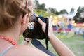 Unrecognizable woman photographing senior couple, fun fair Royalty Free Stock Photo