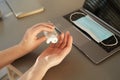 Unrecognizable Woman Sanitizing Hands at Workplace