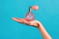 Unrecognizable woman showing transparent perfume bottle in hand Royalty Free Stock Photo