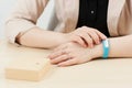 Unrecognizable woman try on blue fitness bracelet